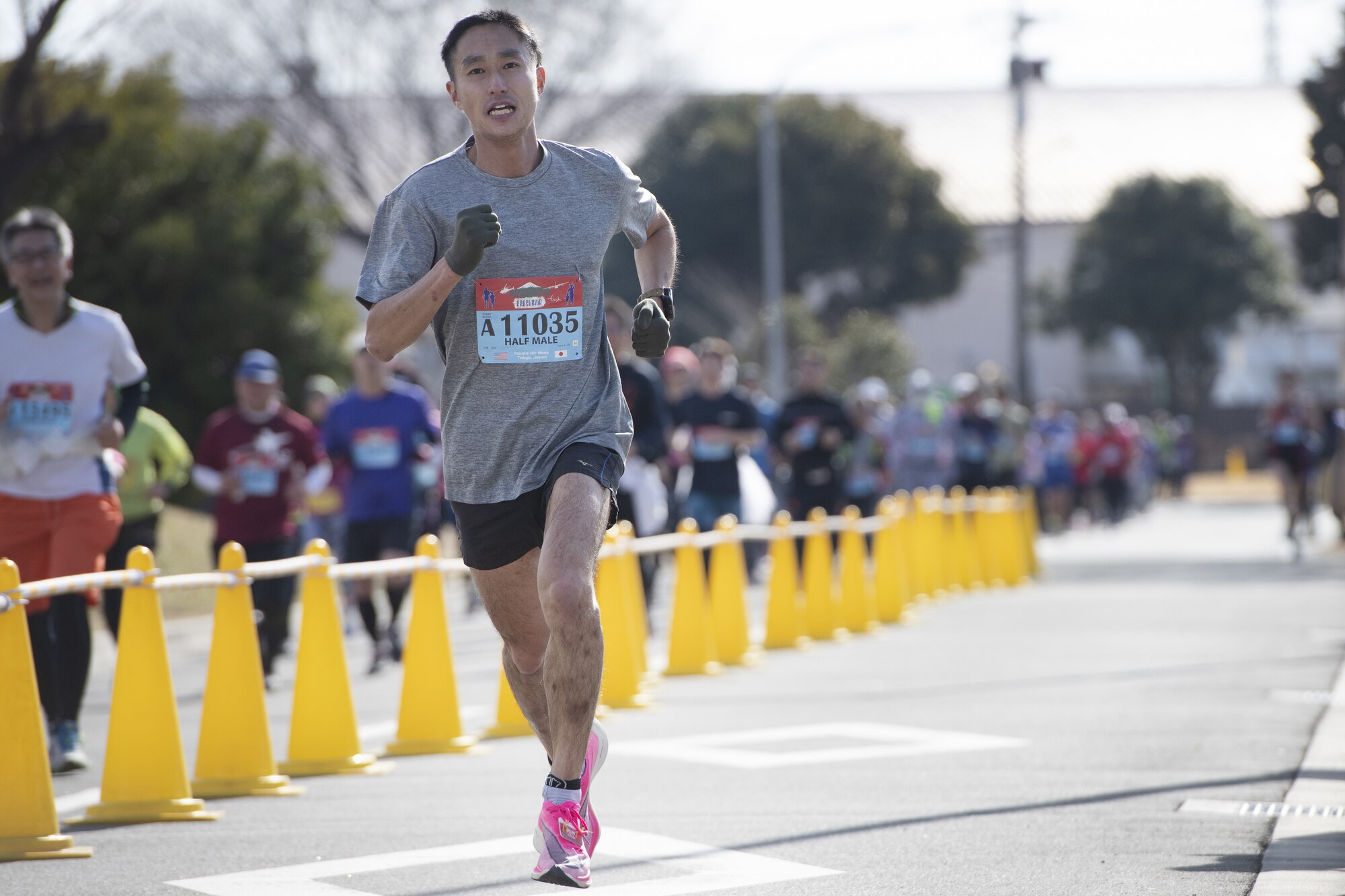 Naoya Ito, a half-marathon race participant, sprints towards the finish line during the 42nd annual Frostbite Road Race.