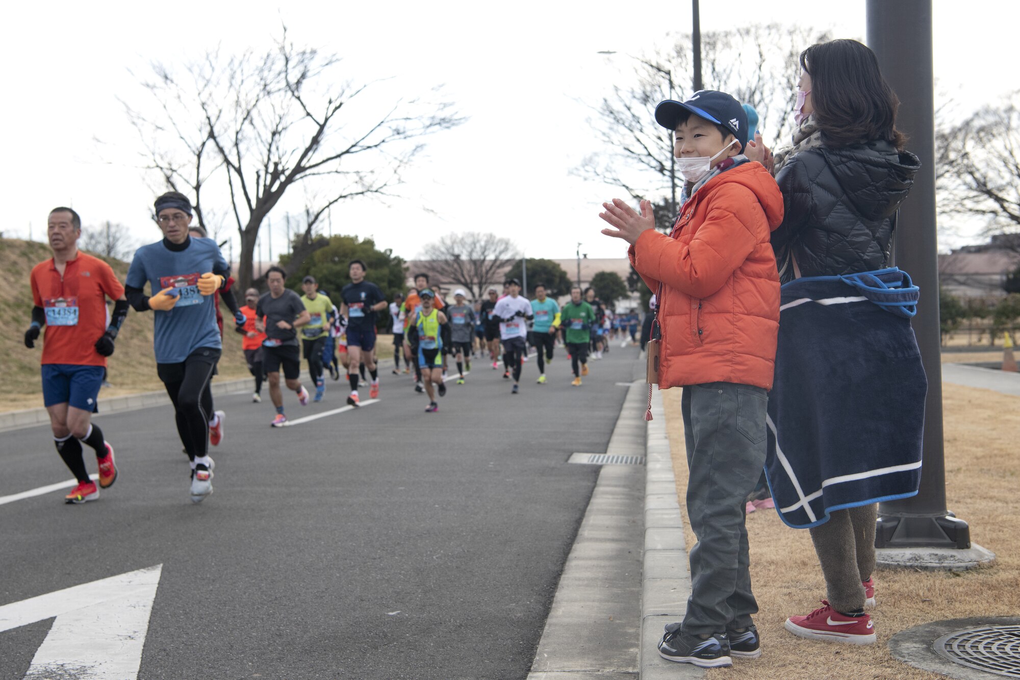 Spectators cheer for half-marathon runners during the 42nd annual Frostbite Road Race.
