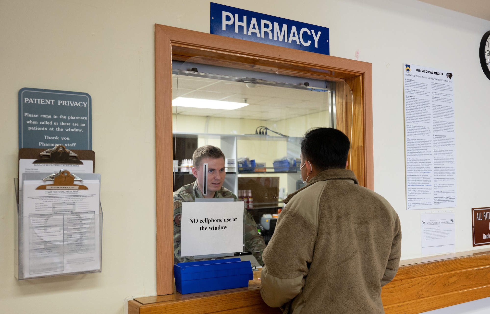Dr. (Maj.) Joshua Dalzell (left), 8th Healthcare Operations Squadron pharmacist, assists a customer at Kunsan Air Base, Republic of Korea, Jan. 18, 2023. The pharmacy provides convenient items for patients such as cold packs to quickly alleviate flu-like symptoms. (U.S. Air Force photo by Staff Sgt. Sadie Colbert)