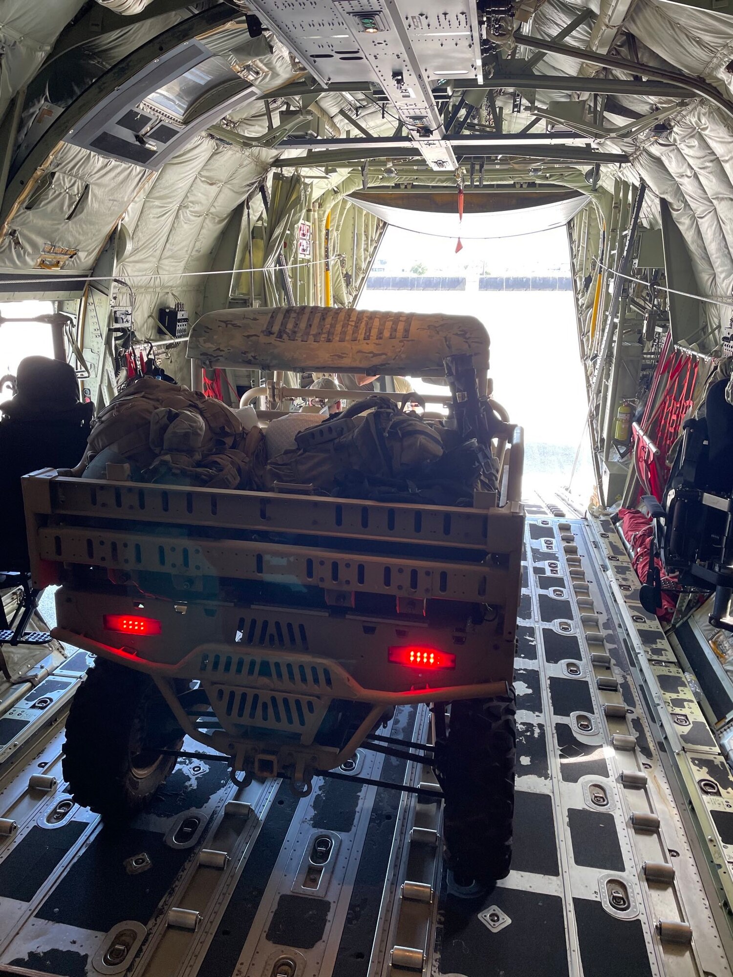 a jeep in the cargo bay of an aircraft