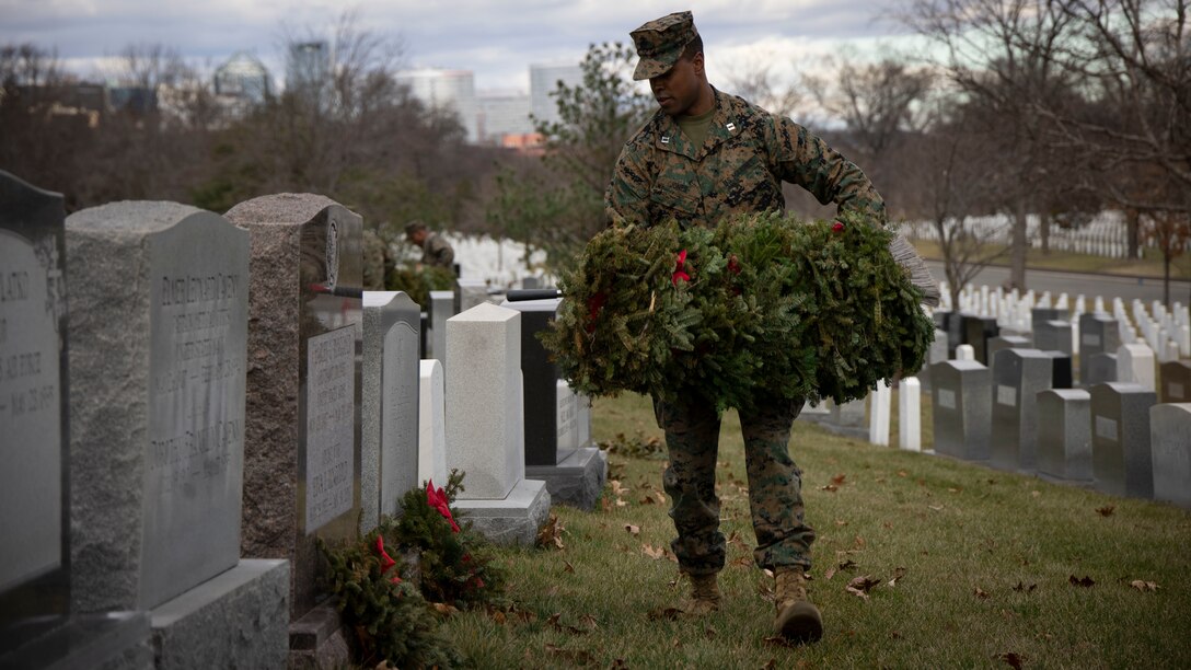 Captain David C. Jones, assistant operations officer, clears wreaths from gravesites at Arlington National Cemetery on Jan 20, 2023. Over the weekend, Marine Barracks Washington had the solemn honor of participating in clearing wreaths from over 250,000 gravesites in remembrance and honor of our nation’s fallen service members and their families. (U.S. Marine Corps photo by Cpl. Mark Morales)