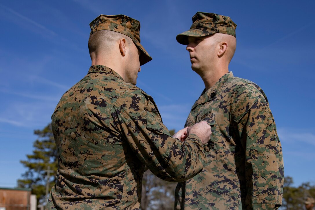 U.S. Marine Corps Lt. Col. Robert D. Barbaree III, left, commanding officer of Headquarters and Headquarters Squadron, Marine Corps Air Station New River, pins the Bronze Star Medal onto Master Sgt. Kevin Haunschild, right, a senior air traffic controller with H&HS, MCAS New River, on MCAS New River in Jacksonville, North Carolina, Jan. 20, 2023. Haunschild received the Bronze Star medal for his actions as Marine Air Traffic Control Mobile Team Leader with Marine Medium Tiltrotor Squadron-162 during Operation Freedom’s Sentinel.