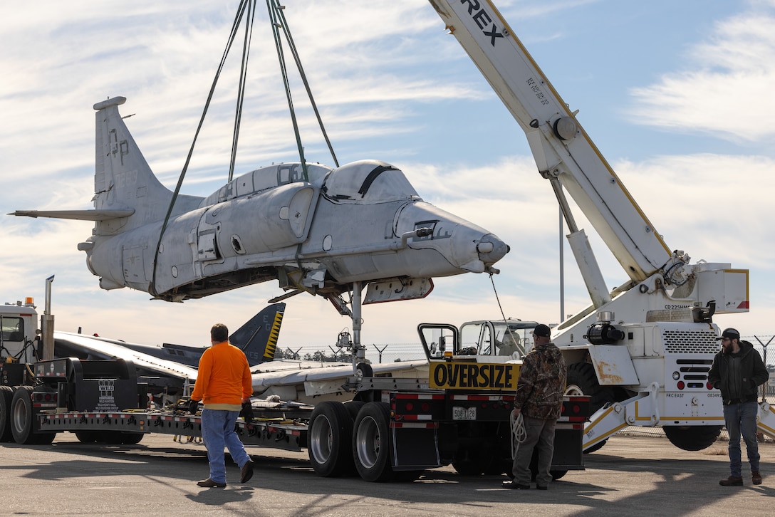 Fleet Readiness Center East (FRCE) contractors lift the body of an A-4M Skyhawk on Marine Corps Air Station Cherry Point, North Carolina, Jan. 10, 2023.  The aircraft was assigned to Marine Attack Squadron-223 from May 1981 to Aug. 1987, where it logged more than 2,102 flight hours. Over the next couple of years, the aircraft will be restored by FRCE and placed in front of the air traffic control tower. (U.S. Marine Corps photo by Lance Cpl. Matthew Williams)