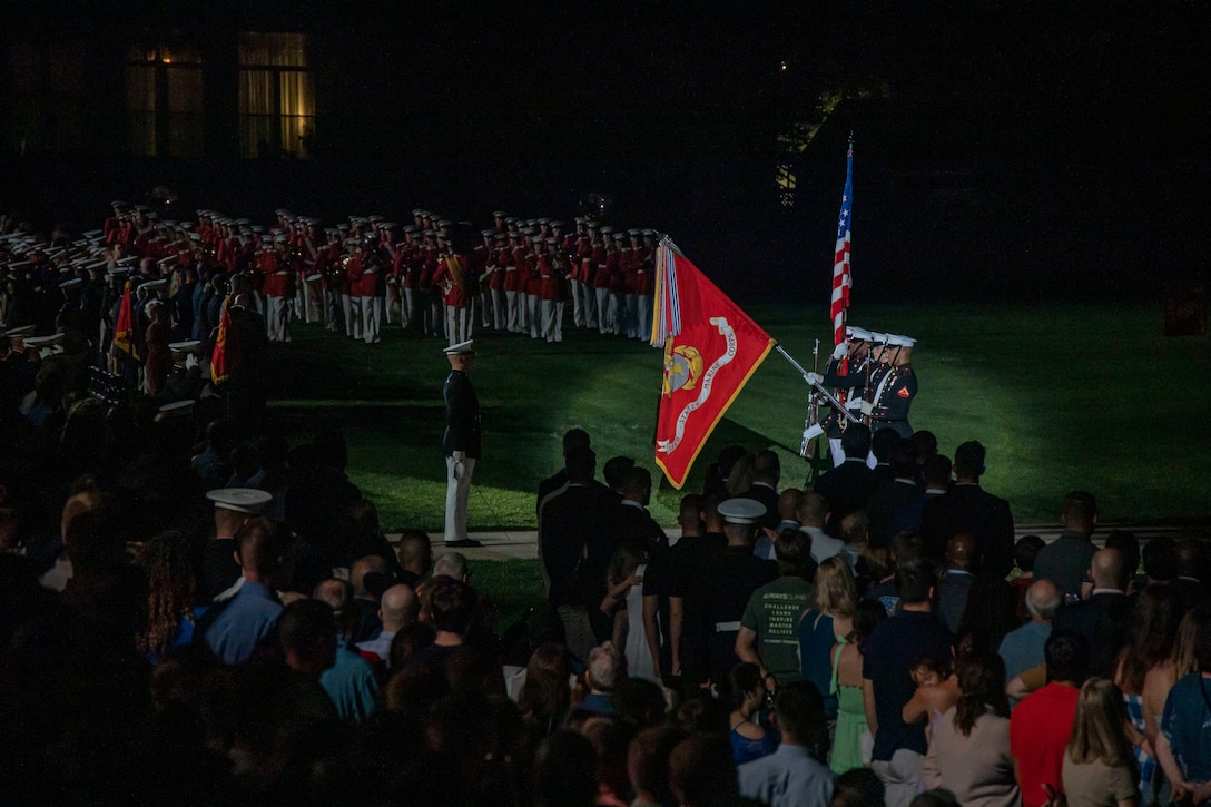 Marines with the Official U.S. Marine Corps Color Guard present the U.S. flag during a Friday Evening Parade at Marine Barracks Washington, D.C., Aug 19, 2022. The guest of honor was The Honorable Carlos F. Matus, Principal Deputy Assistant Secretary and Director of Diplomatic Security Service. The hosting official was Lt. Gen. Gregg Olson, Director of The Marine Corps Staff. (U.S. Marine Corps photo by Cpl. Mark A. Morales)