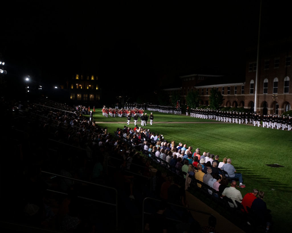 Barracks Marines conduct “pass in review” during a Friday Evening Parade at Marine Barracks Washington, July 8, 2022. The hosting official for the evening was Lieutenant General Christopher J. Majoney, Deputy Commandant for Programs & Resources and Honorable Michael J. McCord, Under Secretary of Defense (Comptroller)/Chief Financial Officer as the guest of honor. (U.S. Marine Corps photo by Cpl. Mark Morales)