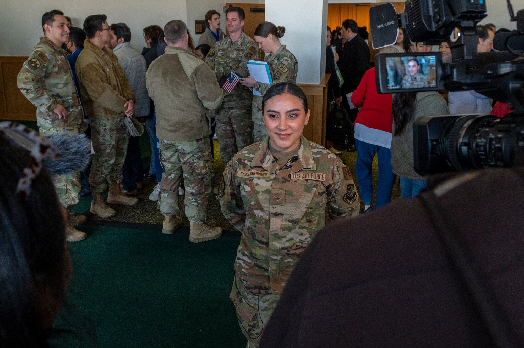 Airman Lissbeth Cardenas Idrovo, 22nd Contracting Squadron contracting specialist, is interviewed by local news networks at the Kansas Naturalization Ceremony Jan. 20, 2023, in Wichita, Kansas. Cardenas was born in Ecuador and enlisted in the U.S. Air Force after learning about the benefits of the military from a friend in the U.S. Navy. (U.S. Air Force photo by Airman 1st Class Brenden Beezley)