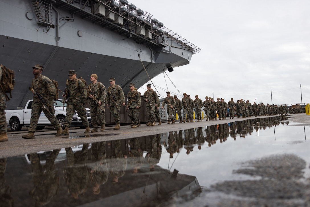U.S. Marines prepare to board the Wasp-class amphibious assault ship USS Bataan (LHD 5) during PHIBRON-MEU Integrated Training (PMINT) at Naval Station Norfolk, Virginia, Jan. 22, 2023. PMINT is the first at-sea period in the intermediate stage of the MEU’s Predeployment Training Program; it aims to increase interoperability and build relationships between Marines and Sailors. (U.S. Marine Corps photo by Cpl. Kyle Jia)