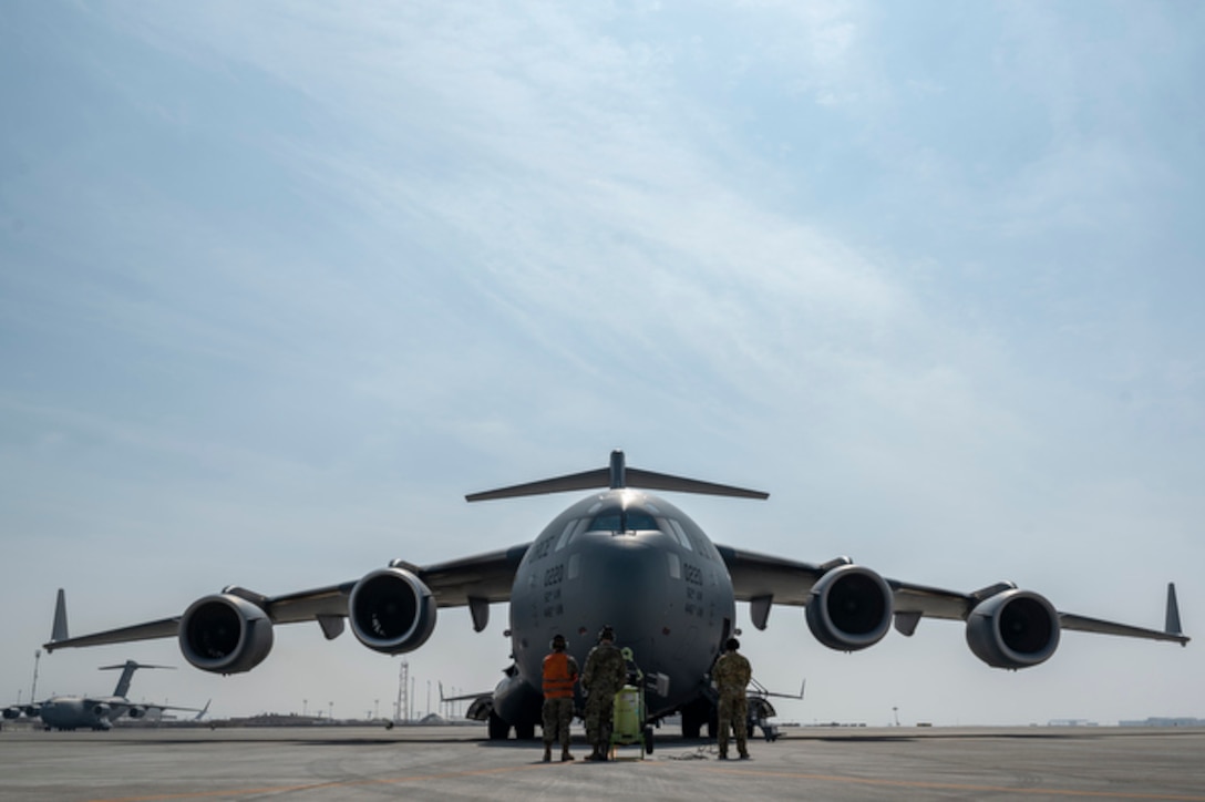 U.S. Air Force C-17 Globemaster III aircrew members assigned to the 8th Expeditionary Airlift Squadron, perform engine start procedures before a tactical combat airlift supporting Exercise Juniper Oak, at Al-Udeid Air Base, Qatar, Jan. 19, 2023. Juniper Oak is a large-scale bilateral exercise, aimed to enhance interoperability between U.S. and Israeli armed forces contributing to regional security. (U.S. Air Force photo by Tech. Sgt. Daniel Asselta)