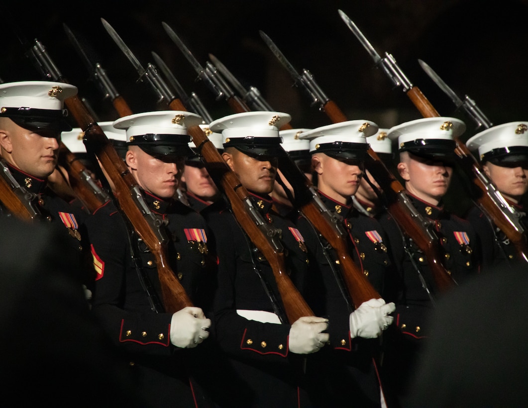 Barracks Marines with Alpha Company, execute “eyes right” during a Friday Evening Parade at Marine Barracks Washington, Aug 12, 2022. The hosting official for the evening was Sgt Maj. Troy E. Black, 19th Sergeant Major of the Marine Corps. The guests of honor were Sgt Maj. Alford L. McMichael, 14th Sergeant Major of the Marine Corps (USMC Ret) and Sgt Maj. Lewis G. Lee, 13th Sergeant Major of the Marine Corps (USMC Ret). (U.S. Marine Corps photo by LCpl. Pranav Ramakrishna)