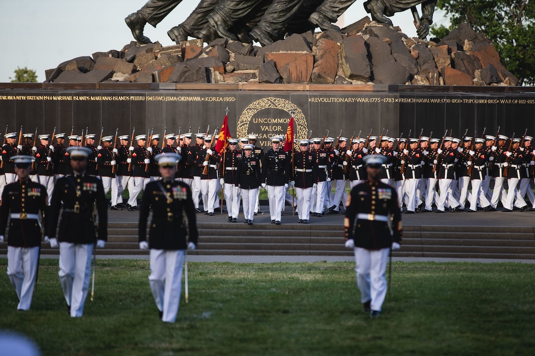 Marines with Marine Barracks Washington march into formation during a Sunset Parade at the Marine Corps War Memorial, Arlington, Va., June 28, 2022. The guest of honor for the evening was the Honorable John P. Coffey, The General Counsel of the Navy and Mr. Mark A. Romano, Counselor for the Commandant, was the hosting official. (U.S. Marine Corps photo by Cpl. Mark Morales)