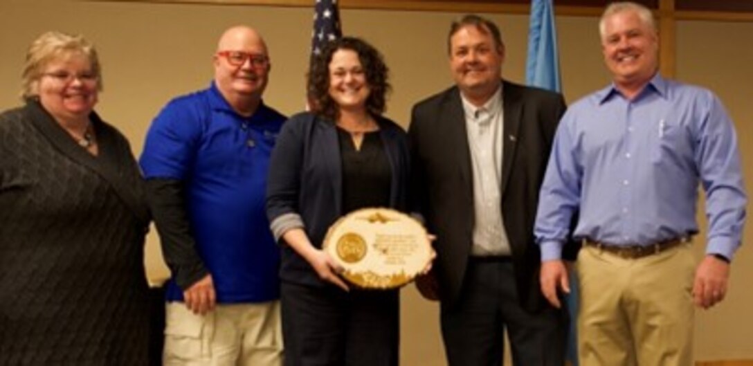 Lynn Kendall, Black Hills Energy community relations manager (center), was recognized by members of the Black Hills Military Advisory Coalition for her involvement and dedication to programs like the Ellsworth Honorary Commanders at the conclusion of the Ellsworth Honorary Commander hail and farewell luncheon Jan. 18 at The Monument in Rapid City, S.D. Kendall, an Air Force veteran, works closely with the base public affairs office to answer questions about the honorary commander program that is designed to foster positive relationships between Air Force leaders and the base’s neighbors throughout the Black Hills. (U.S. Air Force photo by Senior Airman Austin McIntosh)