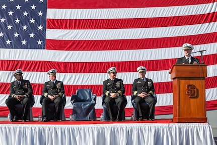 Capt. Kevin Ralston, far right, addresses the crew of amphibious transport dock USS San Diego for the last time as commanding officer during a change of command ceremony held aboard the ship, Jan. 20, 2023. Capt. David Walton relieved Ralston as commanding officer of San Diego during the ceremony.