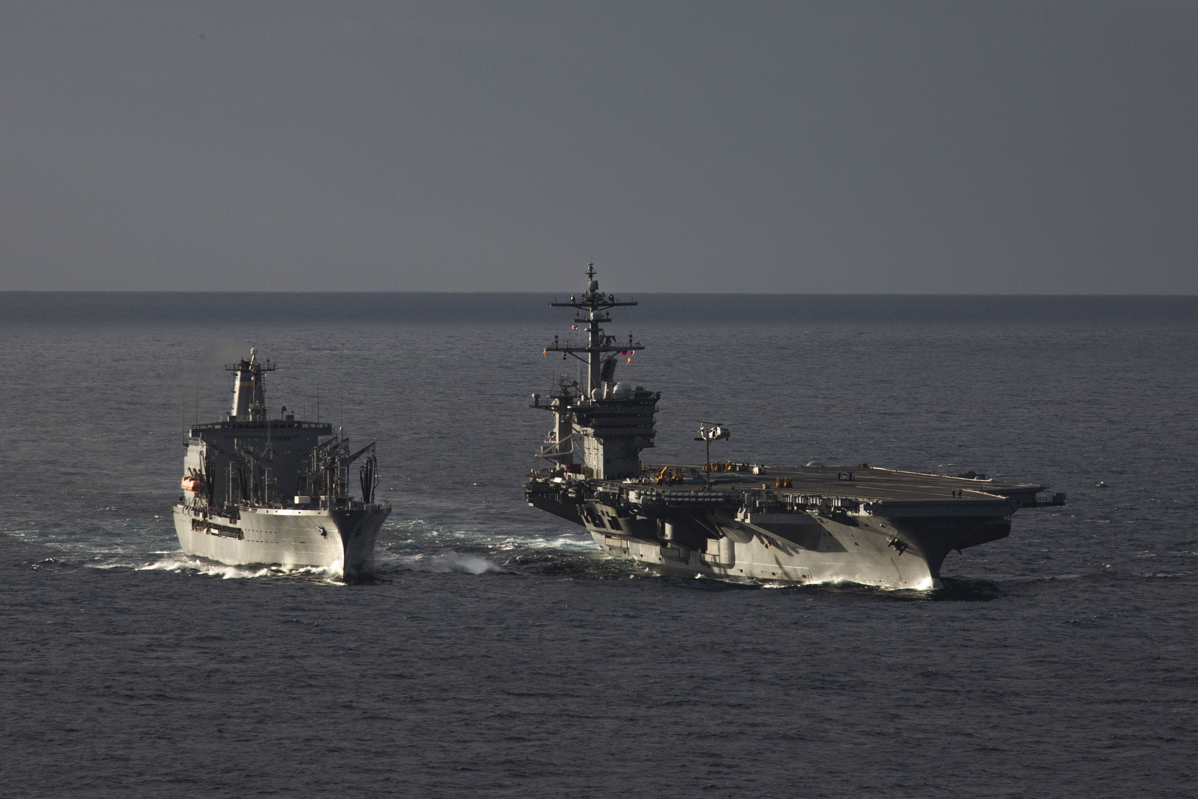 Nimitz-class aircraft carrier USS Abraham Lincoln (CVN 72) conducts an ammunition transfer with the Nimitz-class aircraft carrier USS Carl Vinson (CVN 70) during a replenishment-at-sea with fleet replenishment oiler USNS Henry J. Kaiser (T-AO-187), Jan. 20, 2023.