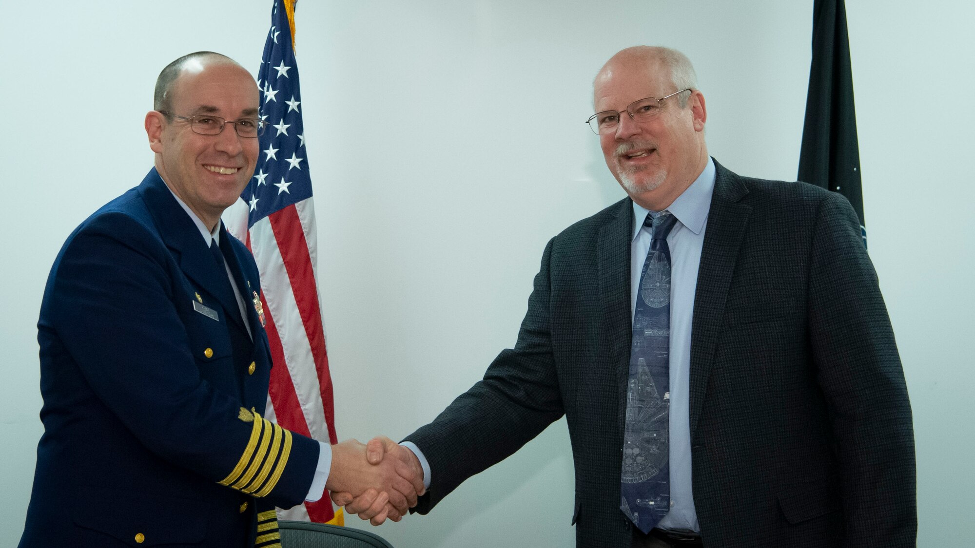 Dr. Joel Mozer, United States Space Force Director of Science, Technology and Research, and U.S. Coast Guard Capt. Dan Keane, Coast Guard Research and Development Center commanding officer, sign a Memorandum of Understanding to enhance space-related capabilities for the joint warfighter. This MOU aims to develop a partnership that focuses on coordination, collaboration, and transparency to enhance capabilities and technologies, and to share best practices. (U.S. Air Force photo by Staff Sgt. Stuart Bright)