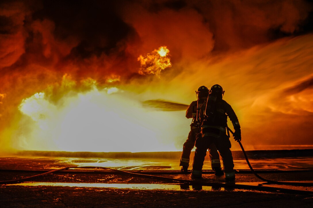 U.S. Marines with Aircraft, Rescue and Firefighting (ARFF), Marine Corps Air Station Cherry Point, put out a controlled fuel burn during a training event at MCAS Cherry Point, North Carolina, Jan. 11, 2023. The training tested a new firehose developed by Oshkosh for the P-19R firetrucks before the equipment becomes standard issue for Marine Corps ARFF and Expeditionary Fire and Rescue operations. (U.S. Marine Corps photo by Lance Cpl. Lauralle Walker)