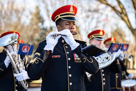 Close-up of an Army band member playing the piccolo.