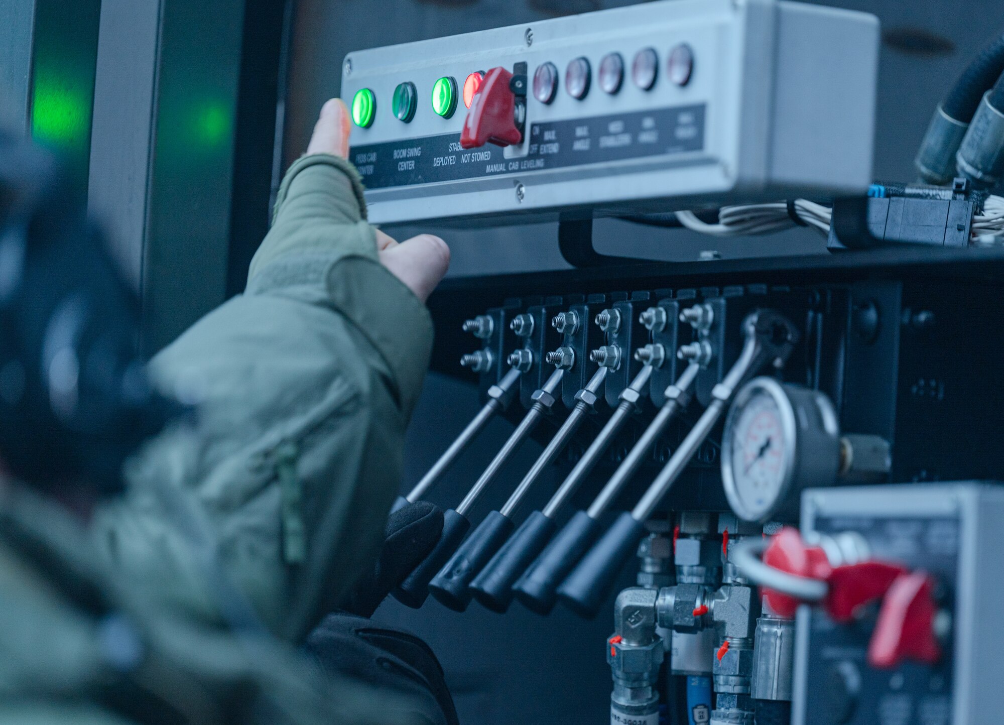 Lithuanian air force airman 1st Class Gintaras Fokas, Terminal Operations Squadron liquid section specialist, controls the emergency panel on the Global ER-2875 de-icer during emergency training on Jan. 18, 2023, at Šiauliai Air Base, Lithuania. Emergency training teaches Lithuanian airmen how to safely bring the basket of a Global ER-2875 de-icer down in an emergency situation. (U.S. Air Force photo by Airman 1st Class Edgar Grimaldo)