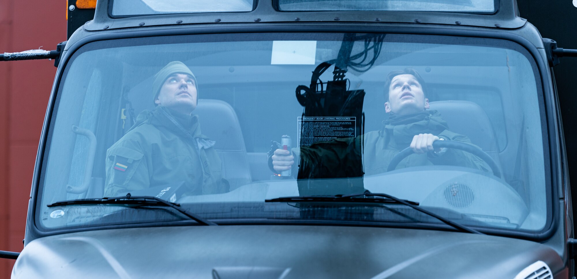 Lithuanian air force airman Gytis Beresnevicius, Terminal Operation Squadron liquid section specialist, right, and Airman 1st Class Darius Leckauskas, liquid section specialist, left, control a Global ER-2875 de-icer during emergency training, Jan. 19, 2023, at Šiauliai Air Base, Lithuania. Lithuanian airmen assigned to the TOS perform emergency procedures in case of basket malfunction. (U.S. Air Force photo by Airman 1st Class Edgar Grimaldo)