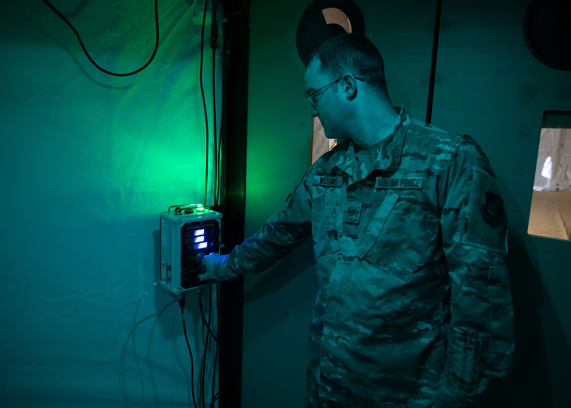 Tech. Sgt. Jordan Williams, 354th Medical Group NCO in charge of medical materiel from Eielson Air Force Base, Alaska, adjusts a dial on the toxic free area (TFA) control module of a chemical protection system at Kunsan Air Base, Republic of Korea, Jan. 20, 2023. The device regulates the air pressure in the multi-functional entrance, purging any toxic chemicals in the room. (U.S. Air Force photo by Senior Airman Akeem K. Campbell)