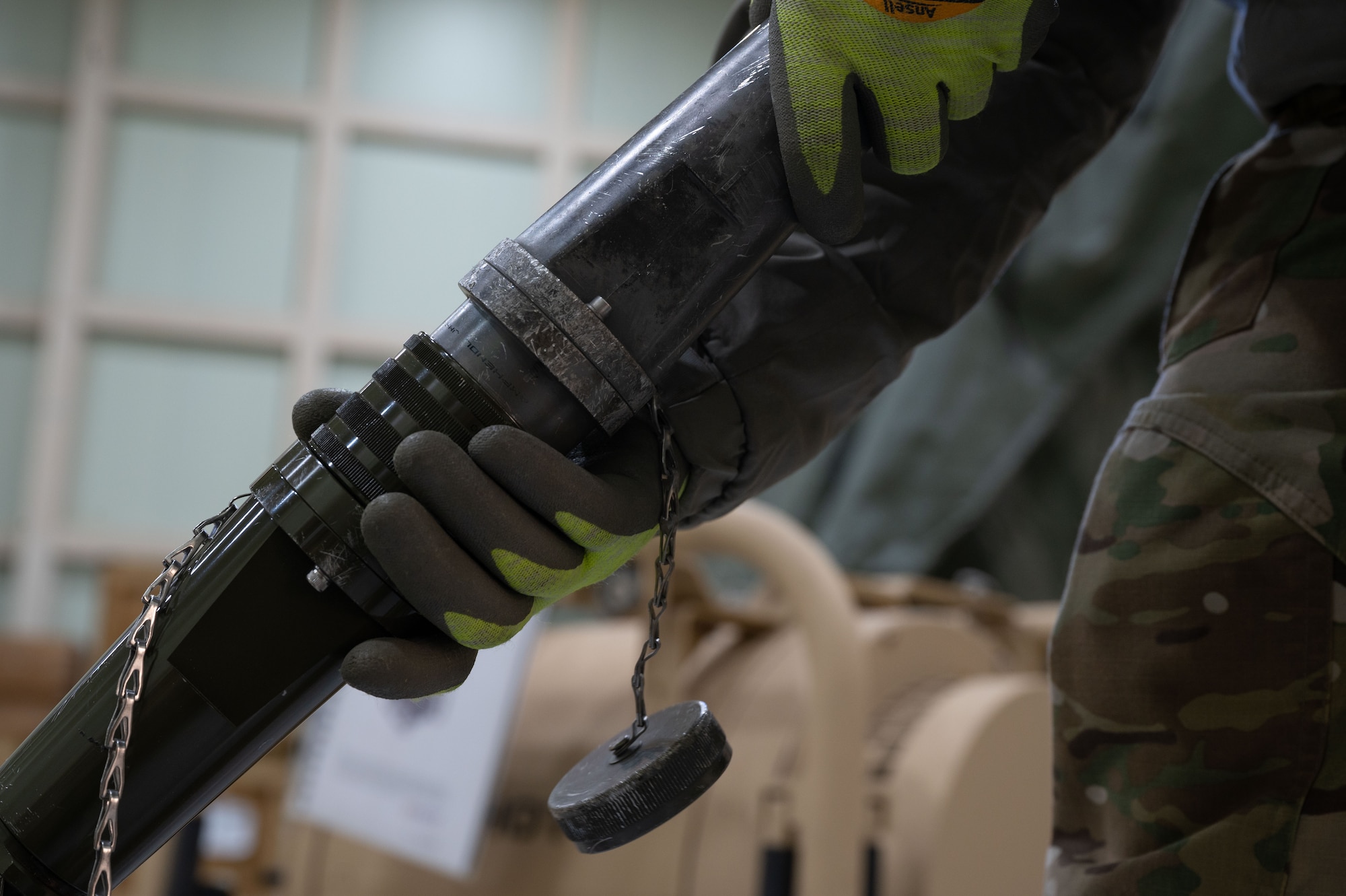 An Airman connects the generator power distribution plug to an environmental control unit plug at Kunsan Air Base, Republic of Korea, Jan. 20, 2023. This connection powers the fan filter assembly, which expands the chemical protection facility. (U.S. Air Force photo by Senior Airman Akeem K. Campbell)