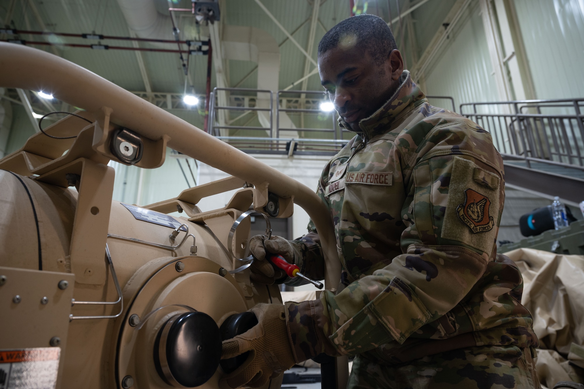 Staff Sgt. Eric Ndapeu, 8th Healthcare Operations Squadron (HCOS) NCO in charge of contingency materiel, sets up the fan filter assembly (FFA) at Kunsan Air Base, Republic of Korea, Jan. 20, 2023. The 8th HCOS installed two FFAs for the tent kit 2 chemical protection system, one for the toxic-free area and the multi-functional entrance, aiding in equalizing the air pressure in each room. (U.S. Air Force photo by Senior Airman Akeem K. Campbell)