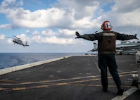 Airman Estefany Rodriguezvegas, assigned to the Nimitz-class aircraft carrier USS George H.W. Bush (CVN 77), directs an MH-60S Nighthawk helicopter, attached to Helicopter Sea Combat Squadron (HSC) 5, from the flight deck Jan. 23, 2023.