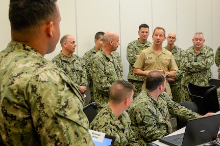 Vice Adm. John B. Mustin, chief of Navy Reserve and commander, Navy Reserve Force, talks to Reserve Sailors participating in MAKO Challenge at the Navy Warfare Development Center in Norfolk. The MAKO Challenge series provides the Navy Reserve an opportunity to enhance their skills and provide continued operational level war support in a realistic, challenging, and dynamically responsive environment.