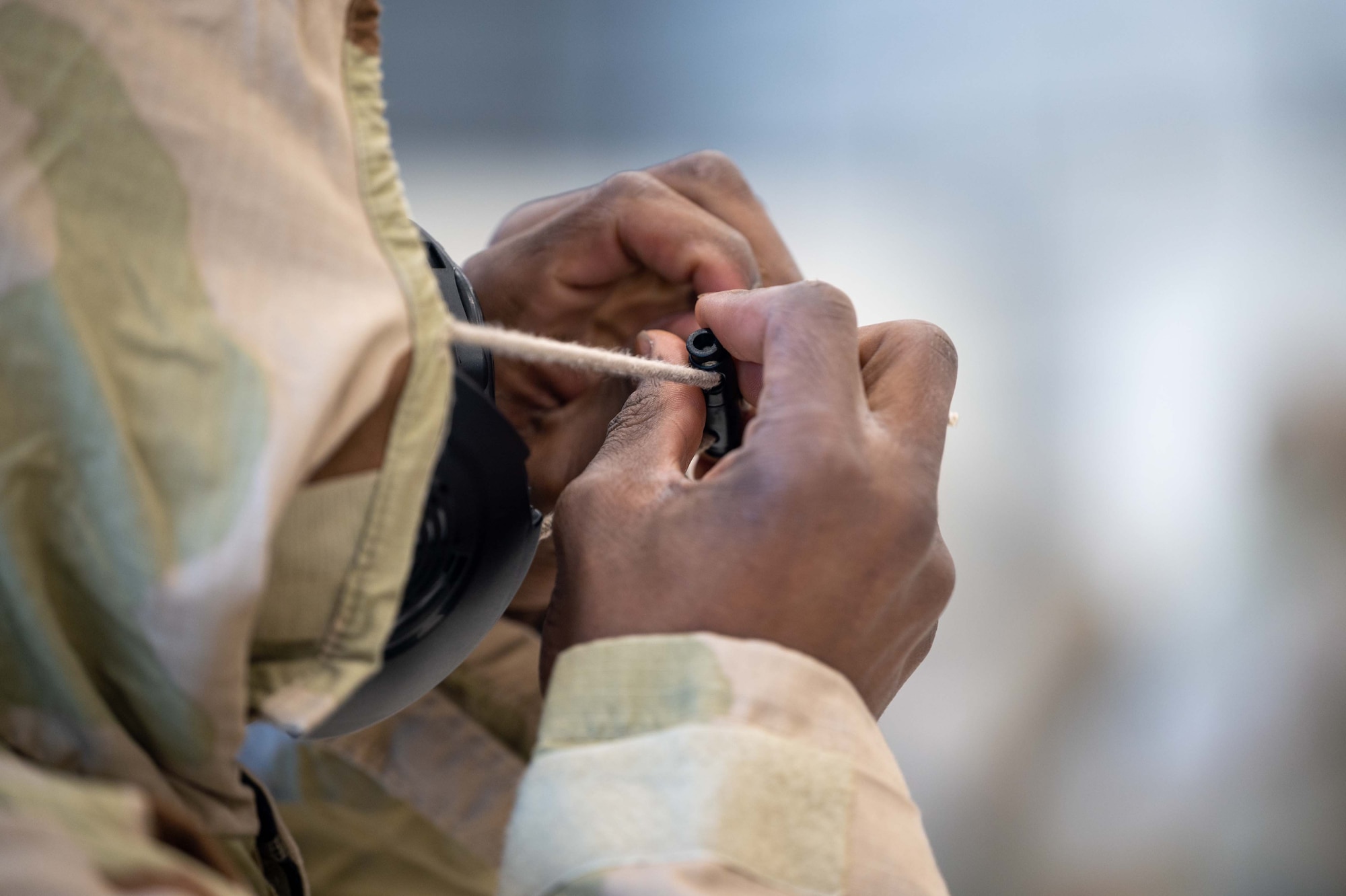Senior Airman Garren Richards, 736th Aircraft Maintenance Squadron C-17 Globemaster III crew chief, puts on Mission-Oriented Protective Posture (MOPP) gear during a 436th MGG Integration Event, at Dover Air Force Base, Delaware, Jan. 20, 2023. Airmen participated in the first-ever 436th MGG Integration Event to test their job-specific career field skills while wearing MOPP gear. (U.S. Air Force photo by Senior Airman Faith Barron)