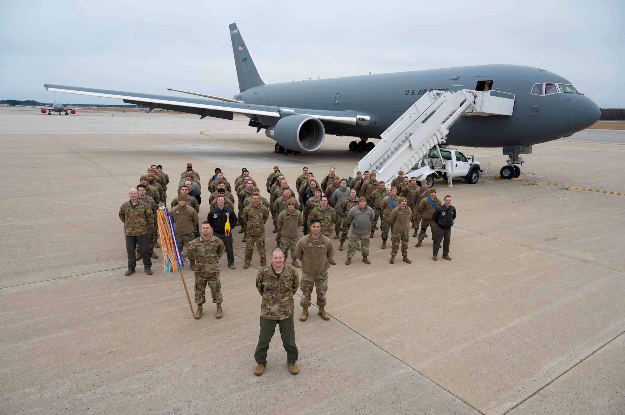 All current 64th ARS members pose for group picture in front of a KC-46.