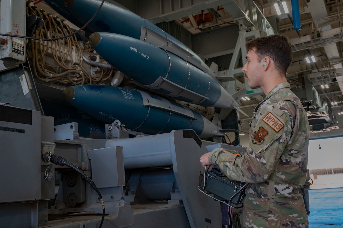 A 7th Aircraft Maintenance Squadron weapons load crew member lowers the Launcher Load Frame during the preparation of transporting the LLF to the flight-line at Dyess Air Force Base, Texas, Jan. 9, 2023.  The LLF is a piece of equipment that allows Weapons Loaders to pre-load munitions on a launcher, under the cover of a facility, prior to transporting the entire launcher/munition package to the flight-line for loading on the aircraft. (U.S. Air Force photo by Senior Airman Josiah Brown)