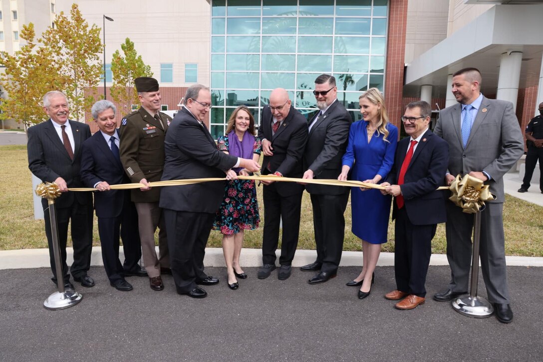 People doing a ribbon cutting.