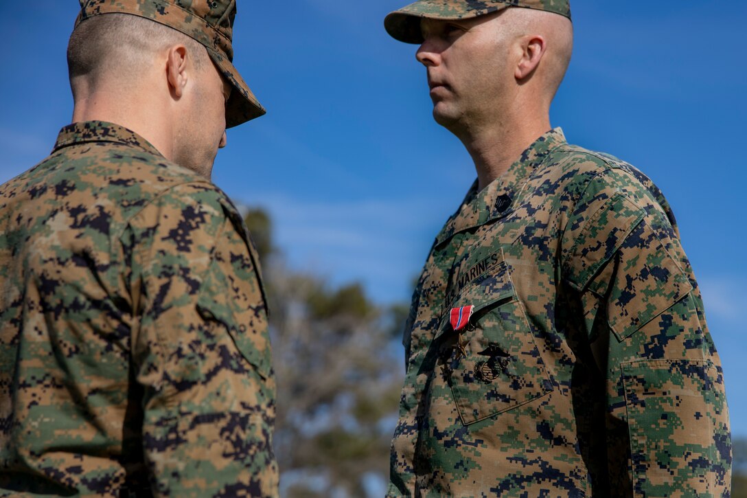 U.S. Marine Corps Lt. Col. Robert D. Barbaree III, left, commanding officer of Headquarters and Headquarters Squadron (H&HS), Marine Corps Air Station (MCAS) New River, awards the Bronze Star Medal to Master Sgt. Kevin Haunschild, right, a senior air traffic controller with H&HS, on MCAS New River in Jacksonville, North Carolina, Jan. 20, 2023. Haunschild received the Bronze Star medal for his actions as Marine Air Traffic Control Mobile Team Leader with Marine Medium Tiltrotor Squadron-162 during Operation Freedom’s Sentinel. (U.S. Marine Corps photo by Cpl. Antonino Mazzamuto)
