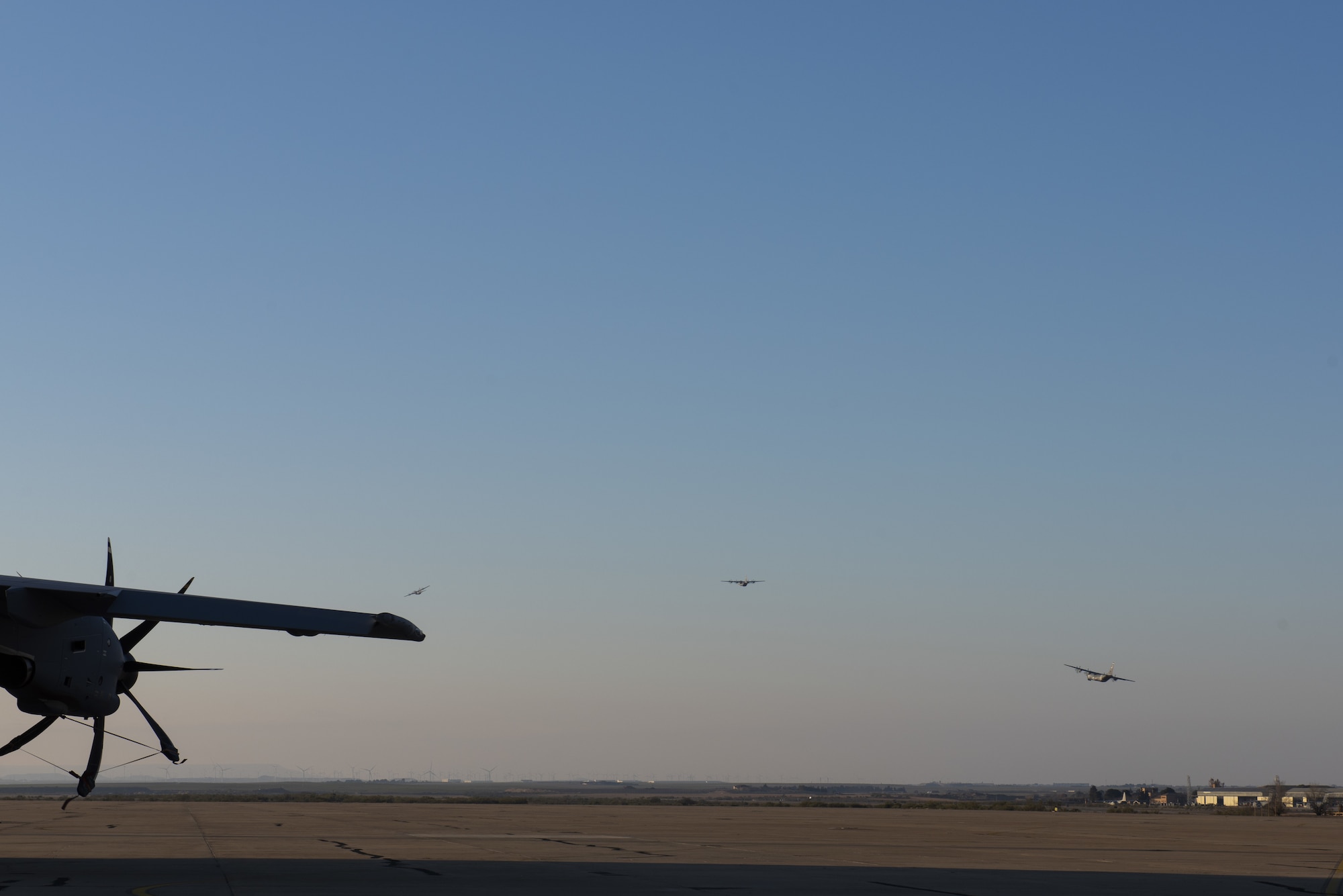 Three aircraft are in the blue sky