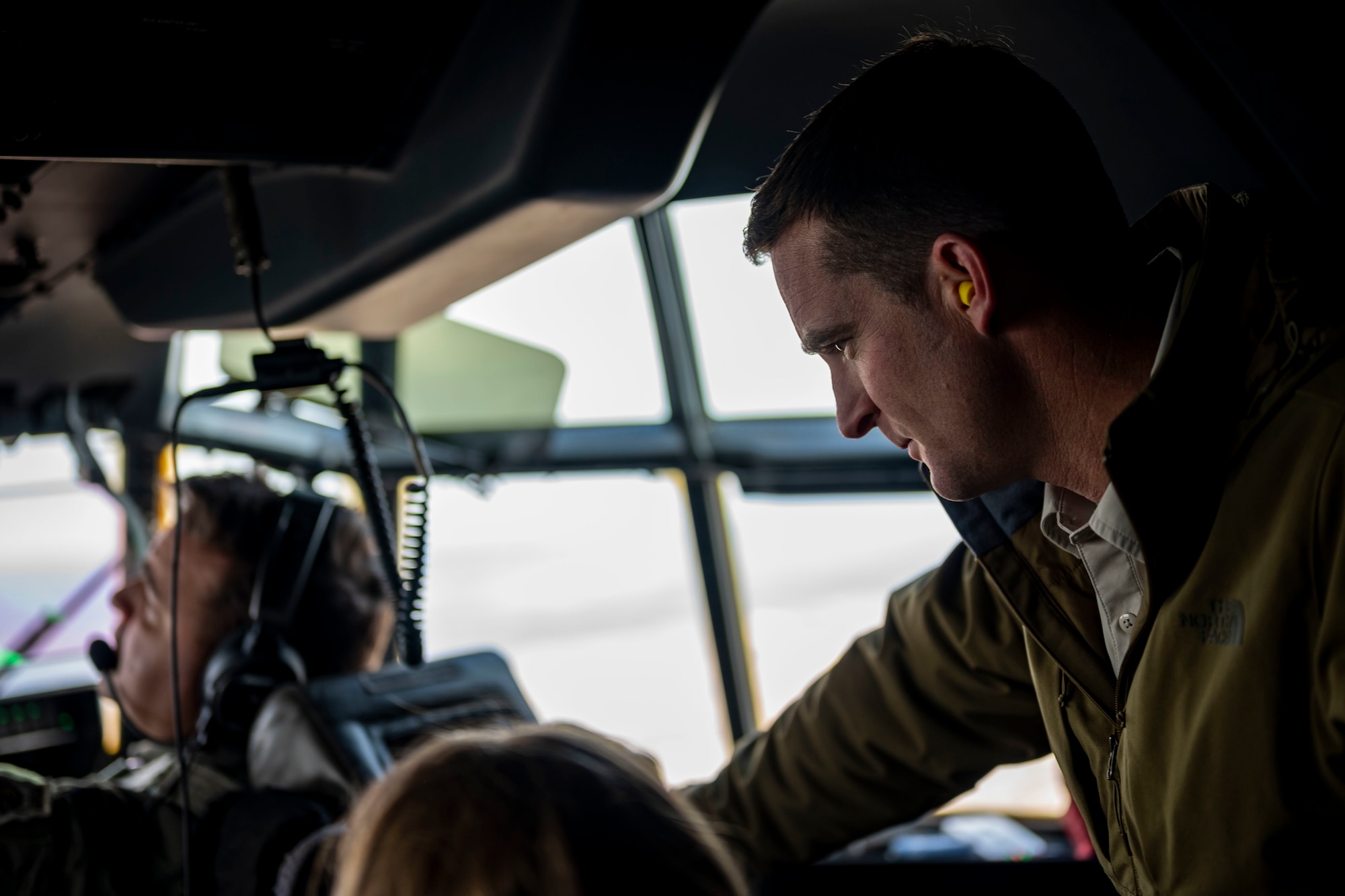 An honorary commander inductee looks out the cockpit of a C-130J Super Hercules during an honorary commander induction tour incentive flight at Dyess Air Force Base, Texas, Jan. 20, 2023. The Honorary Commander Program is an executive-level program intended to educate community members who have limited knowledge of the Air Force and Dyess to foster public support for the base and its Airmen and families. (U.S. Air Force photo by Senior Airman Leon Redfern)
