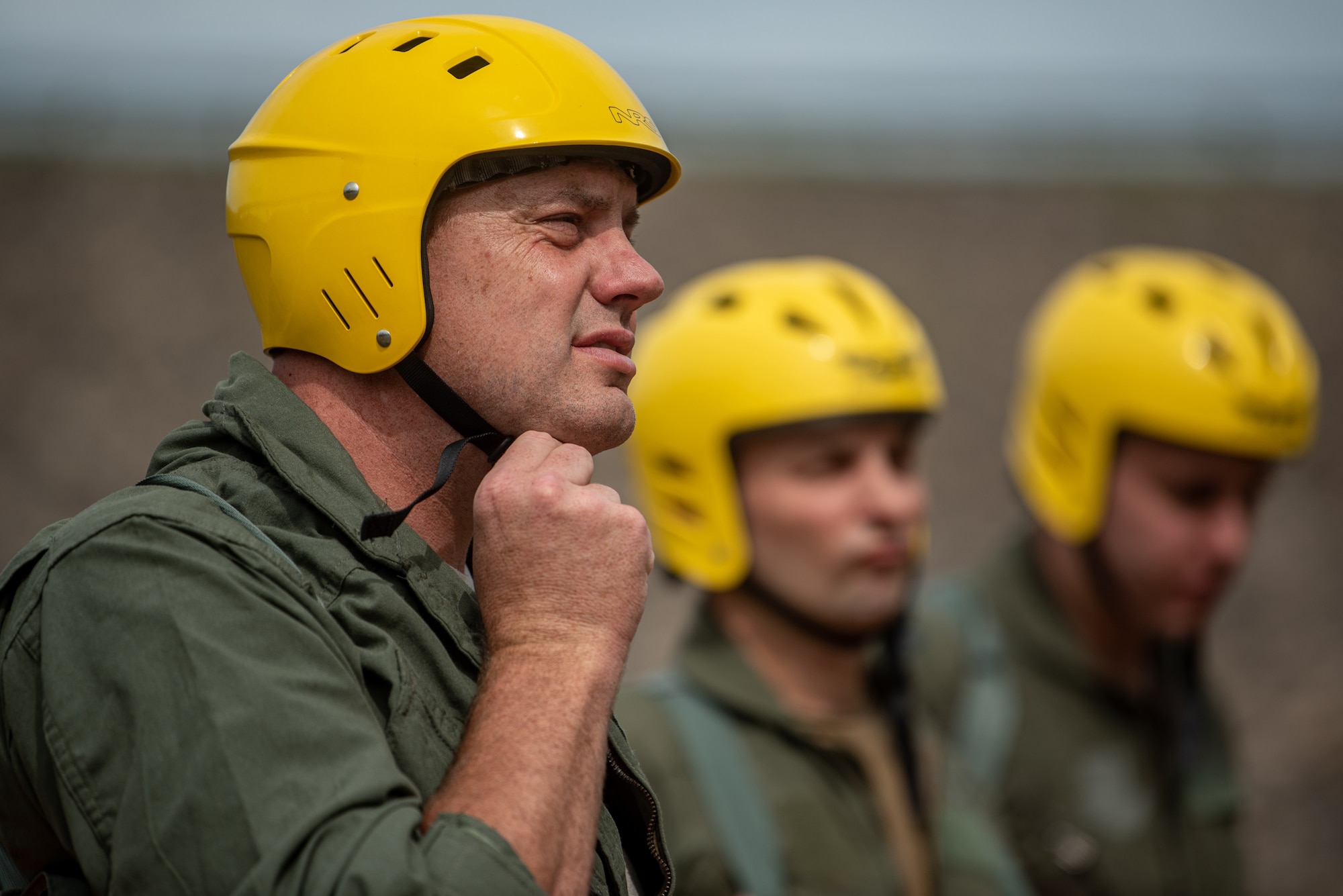 Maj. Andrew Hutchinson, a pilot for the Kentucky Air National Guard’s 165th Airlift Squadron, dons a safety helmet in preparation for water survival training at Taylorsville Lake in Spencer County, Ky., Sept. 10, 2022. The annual training refreshes aircrew members on skills learned during U.S. Air Force Survival School. (U.S. Air National Guard photo by Tech. Sgt. Joshua Horton)