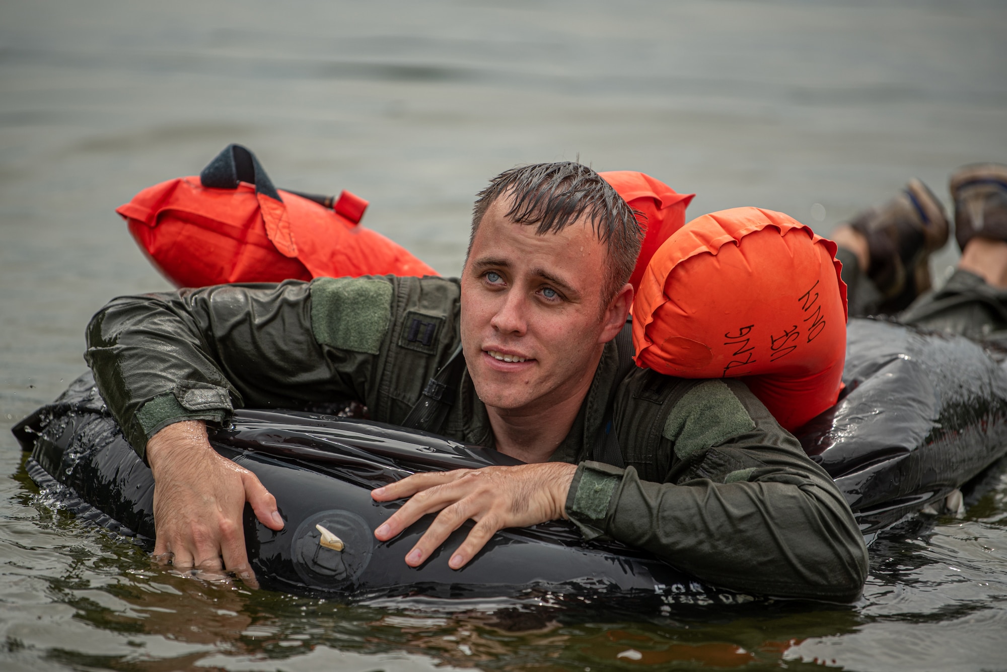 Capt. Travis Carter, a pilot for the Kentucky Air National Guard’s 165th Airlift Squadron, mounts a LRU-16/P life raft during water survival training at Taylorsville Lake in Spencer County, Ky., Sept. 10, 2022. The annual training refreshes aircrew members on skills learned during U.S. Air Force Survival School. (U.S. Air National Guard photo by Tech. Sgt. Joshua Horton)