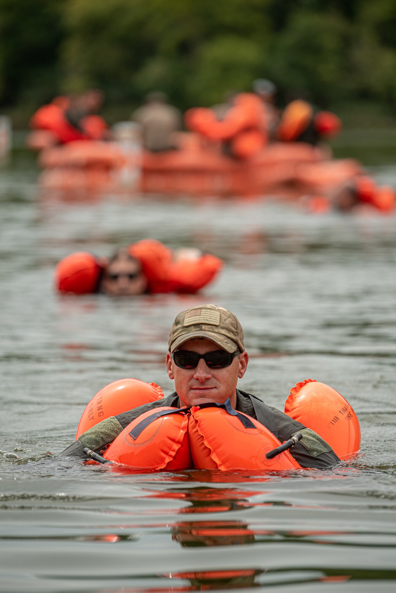 Chief Master Sgt. Bradley Simms, a loadmaster for the Kentucky Air National Guard’s 165th Airlift Squadron, swims back to shore after exiting an F2B life raft during water survival training at Taylorsville Lake in Spencer County, Ky., Sept. 10, 2022. The annual training refreshes aircrew members on skills learned during U.S. Air Force Survival School. (U.S. Air National Guard photo by Tech. Sgt. Joshua Horton)