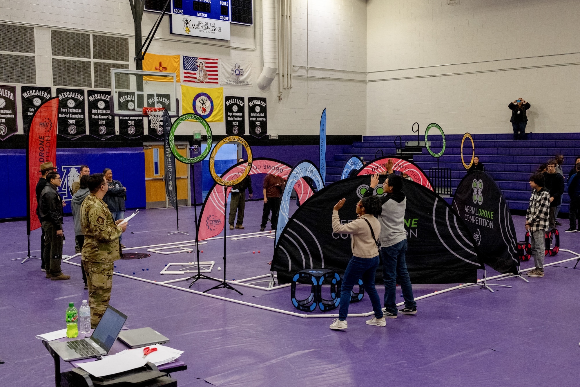 Students from Mescalero Apache High School, Farmington High School and J.M. Hanks High School, participate in the first Annual Aerial Drone Competition at Mescalero Apache High School, Jan. 21, 2023. The competition is sponsored by the Robotics Education and Competition Foundation and is played on a 24'x24' square field, with two alliances - made up of two teams - each competing in 2-minute pilot-operated matches. (U.S. Air Force photo by Senior Airman Antonio Salfran)