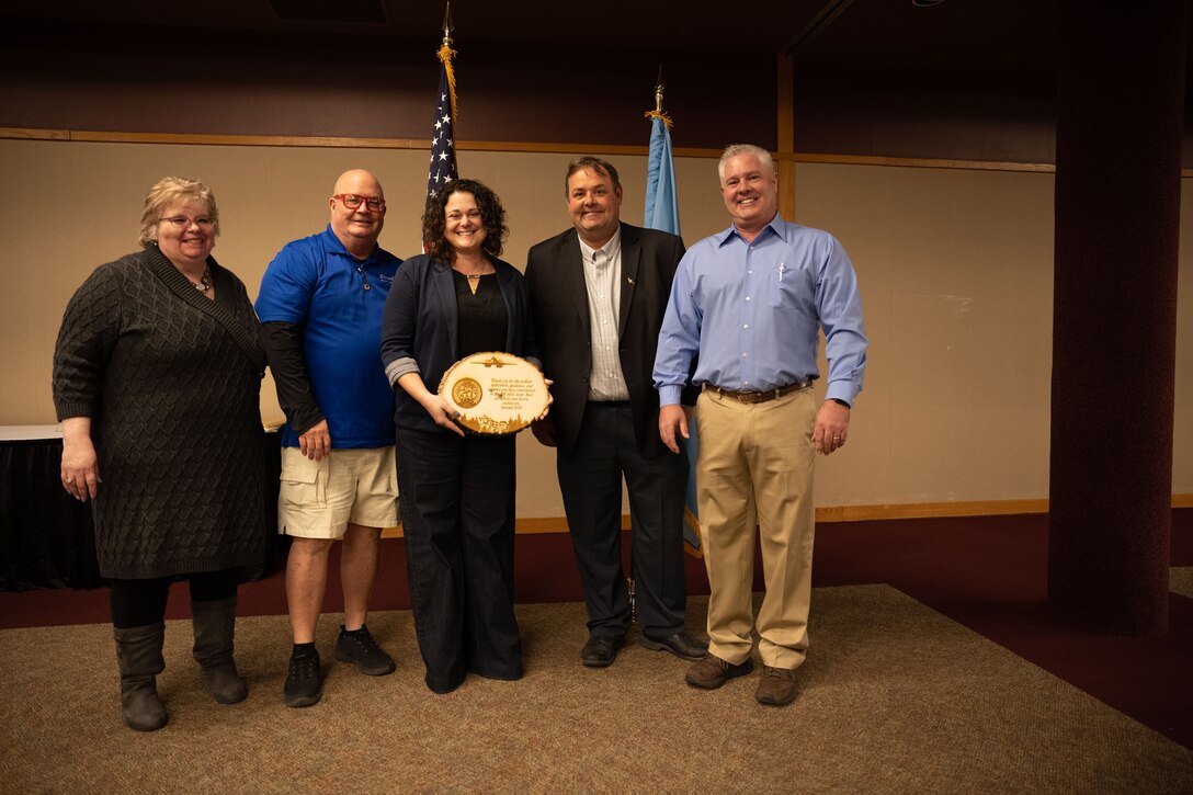 Lynn Kendall, Black Hills Energy community relations manager (center), was recognized by members of the Black Hills Military Advisory Coalition for her involvement and dedication to programs like the Ellsworth Honorary Commanders at the conclusion of the Ellsworth Honorary Commander hail and farewell luncheon Jan. 18 at The Monument in Rapid City, S.D. Kendall, an Air Force veteran, works closely with the base public affairs office to answer questions about the honorary commander program that is designed to foster positive relationships between Air Force leaders and the base’s neighbors throughout the Black Hills. (U.S. Air Force photo by Senior Airman Austin McIntosh)