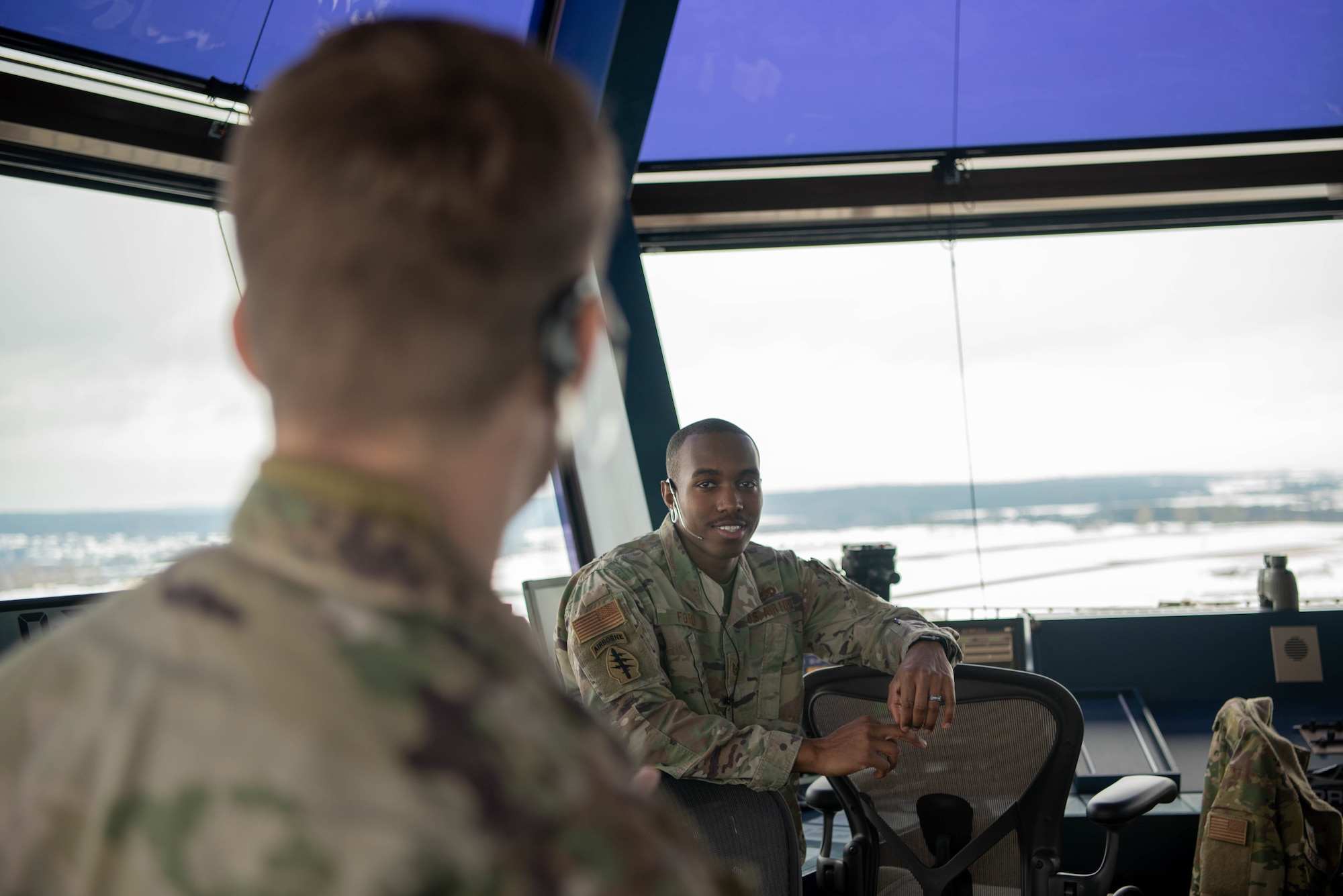 A service member talks to another service member.