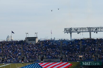 Two CH-47 Chinook helicopters assigned to 29th Combat Aviation Brigade, Maryland Army National Guard conduct a flyover on Nov. 7, 2021, at the M&T Bank Stadium, Baltimore. The flyover was as part of the pre-game ceremonies of the Baltimore Ravens' Salute to Service game which simultaneously included Maryland National Guard Soldiers and Airmen unfurling an United States flag on the field.