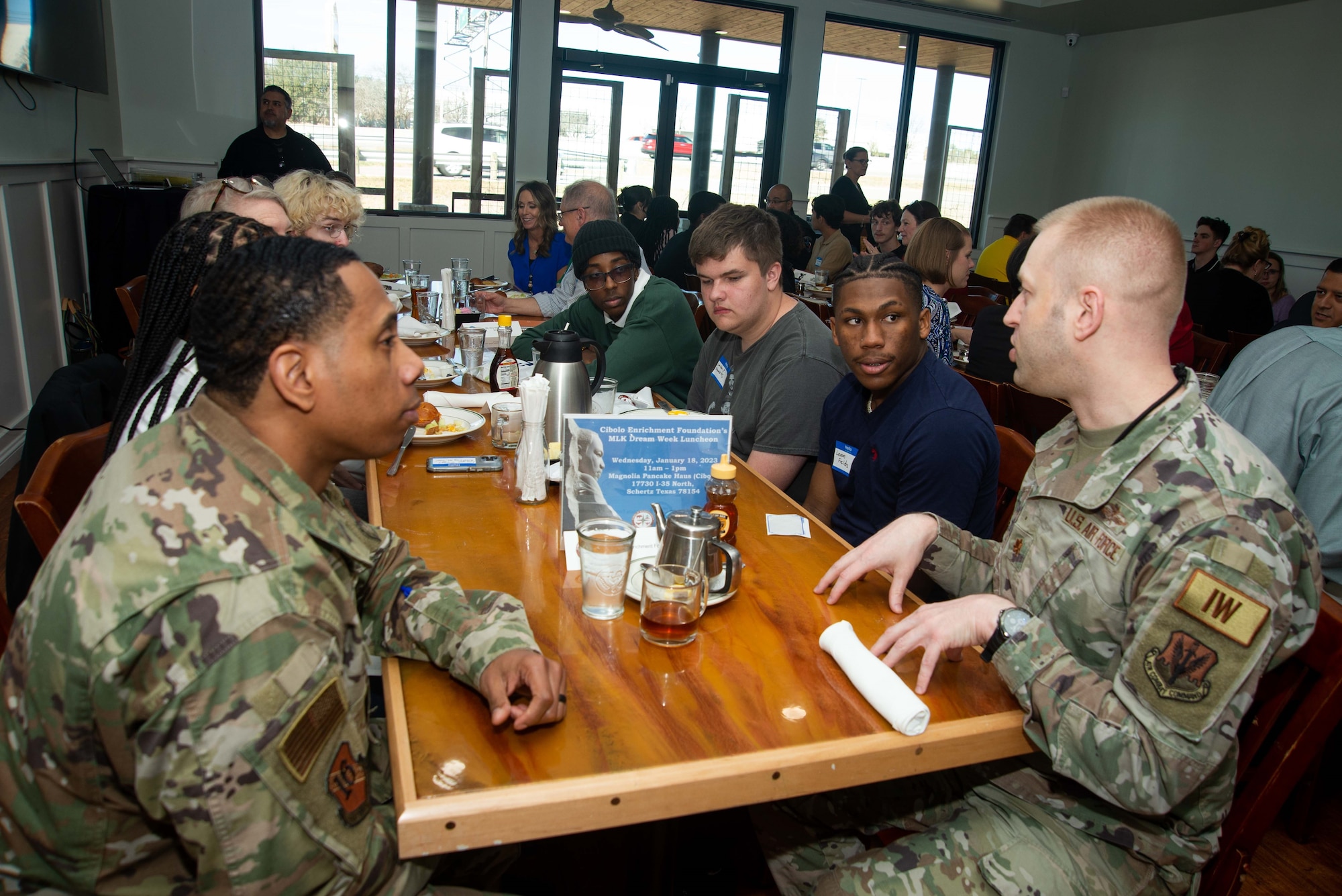 Two military people discuss careers with students.