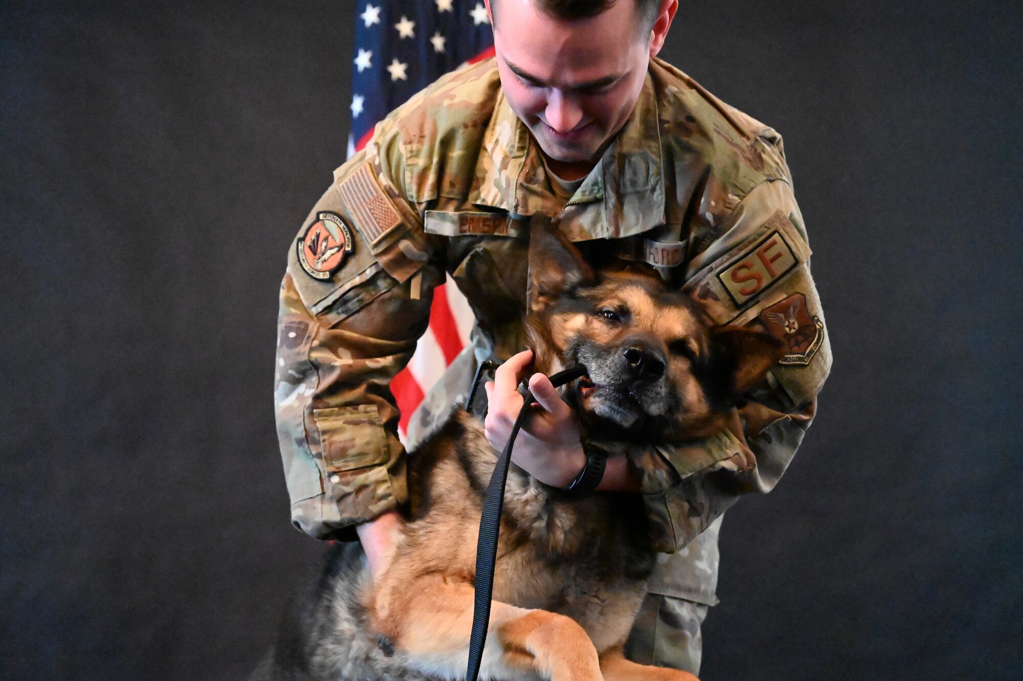 military working day getting an official photo taken with his handler