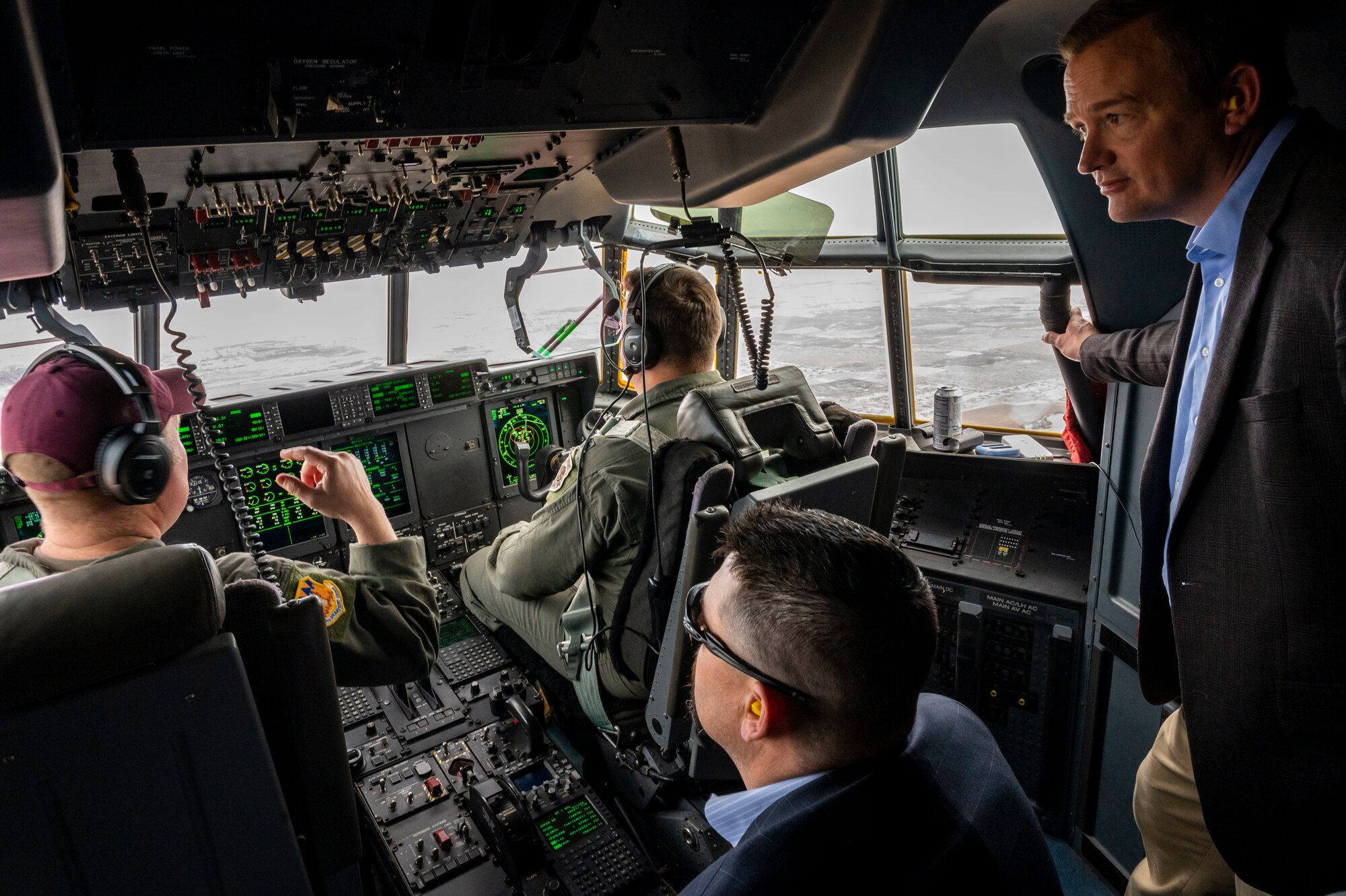 Honorary commander inductees stand in the cockpit of a C-130J Super Hercules during an honorary commander induction tour incentive flight at Dyess Air Force Base, Texas, Jan. 20, 2023. Dyess unit commanders are encouraged to immerse their assigned honorary commanders into their respective missions. Honorary commanders are likewise encouraged to share their civilian professions and business with the Airmen in their assigned units. (U.S. Air Force photo by Senior Airman Leon Redfern)