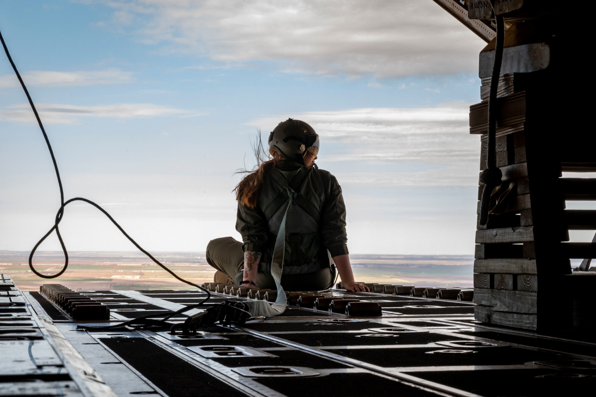 U.S. Air Force Staff Sgt. Kirby Graves, 40th Airlift Squadron loadmaster, sits on the edge of a C-130J Super Hercules during an Honorary Commander Induction tour incentive flight at Dyess Air Force Base, Texas, Jan. 20, 2023. The program also serves as a forum in which Dyess commanders can solicit advice and support from their civic leader counterparts on matters affecting military and civilian communities. Honorary commanders will be assigned to unit commanders serving in the 7th Bomb Wing, 317th Airlift Wing, 489th Bomb Group, 436th Training Squadron, 337th Test Evaluation Squadron, 77th Weapons Squadron and Det. 1 U.S. Marine Corps. (U.S. Air Force photo by Senior Airman Leon Redfern)
