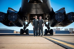 U.S. Air Force Maj. Lauren Olme, 77th Weapons Squadron assistant director of operations, and her husband, Maj. Mark Olme, 7th Operations Support Squadron bomb wing weapons officer, pose for a photo next to a B-1B Lancer at Dyess Air Force Base, Texas, Jan. 24, 2023. Lauren, who is currently pregnant, can continue flying after recently getting approved under the Air Force’s new guidance which allows female aircrew members to voluntarily request to fly during pregnancy. No waiver is required to fly in the second trimester with an uncomplicated pregnancy in a non-ejection seat aircraft if all flight safety criteria are met. All pregnant aircrew members are also authorized to apply for a waiver regardless of trimester, aircraft or flight profile. (U.S. Air Force photo by Senior Airman Leon Redfern)