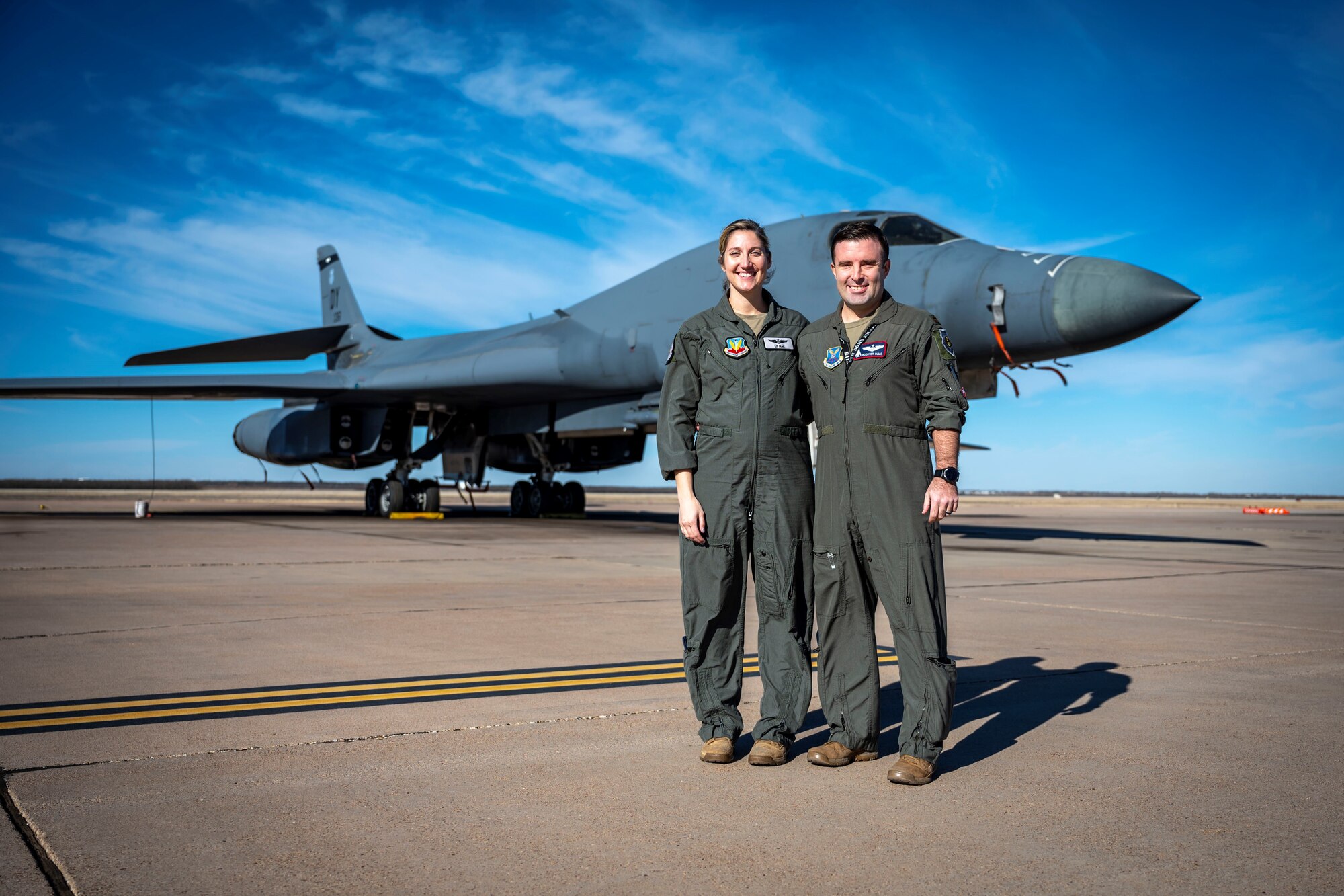U.S. Air Force Maj. Lauren Olme, 77th Weapons Squadron assistant director of operations, and her husband, Maj. Mark Olme, 7th Operations Support Squadron bomb wing weapons officer, pose for a photo next to a B-1B Lancer at Dyess Air Force Base, Texas, Jan. 24, 2023. Lauren, who is currently pregnant, can continue flying after recently getting approved under the Air Force’s new guidance which allows female aircrew members to voluntarily request to fly during pregnancy. No waiver is required to fly in the second trimester with an uncomplicated pregnancy in a non-ejection seat aircraft if all flight safety criteria are met. All pregnant aircrew members are also authorized to apply for a waiver regardless of trimester, aircraft or flight profile. (U.S. Air Force photo by Senior Airman Leon Redfern)