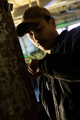 A Sailor repairs an electrical system