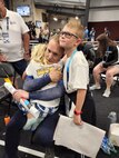 Operations Specialist 1st Class Travis Wyatt hugs his children in an undated photo during his participation in the 2022 Warrior Games.