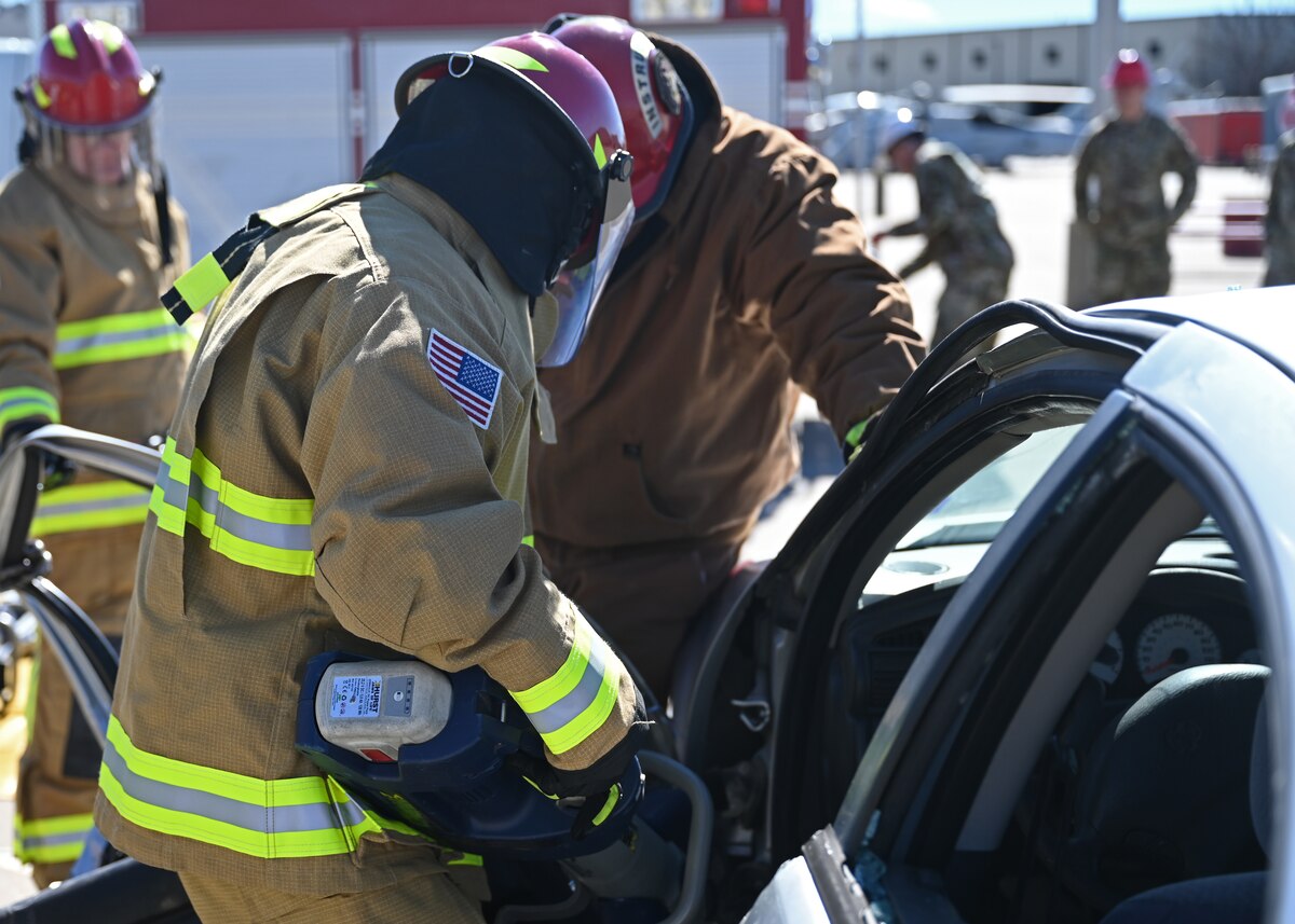 A 17th Training Wing honorary commander uses extraction tools to take off a car door at the Louis F. Garland Department of Defense Fire Academy, Goodfellow Air Force Base, Texas, Jan. 25, 2023. The Honorary Commander Program is used to immerse local community leaders in Goodfellow’s mission. (U.S. Air Force photo by Senior Airman Ethan Sherwood)